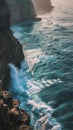 Vertical landscape of ocean beach at sunrise with big waves crashing into rocks Royalty Free Stock Photo