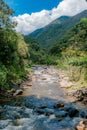 VERTICAL LANDSCAPE OF A RIVER IN THE MIDDLE OF THE JUNGLE MOUNTAINS OF COLOMBIA