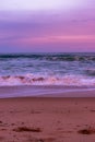 Vertical landscape shot of a beautiful colorful sunset at the beach Royalty Free Stock Photo