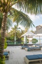 Vertical landscape of sunbeds and umbrellas near swimming pool at beach Royalty Free Stock Photo