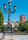 Vertical of a lantern on the square of Bib Rambla in Granada with the bell tower of the cathedral Royalty Free Stock Photo