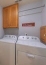 Vertical Laundry room beside the bathroom with large mirror door