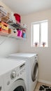 Vertical Laundry room in house with electrical appliances