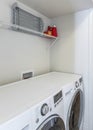 Vertical Laundry room interior with limestone tiles and laundry units