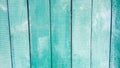 Vertical light emerald green boards of a table, fence, walls tilted in perspective as an abstract vintage old background