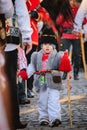 Vertical of a little child dressed in traditional Romanian clothes during the New Year's parade