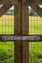 Vertical of locked fence by field Royalty Free Stock Photo