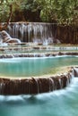 Vertical long exposure shot of the beautiful tropical Kuang Si Waterfall in Luang Prabang, Laos