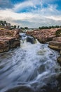 Vertical and long exposure shot of Big Sioux River Falls Park Sioux Falls blue sky, South Dakota Royalty Free Stock Photo