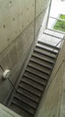 Vertical Looking down on staircase with metal handrails inside of commercial building Royalty Free Stock Photo