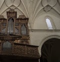 Vertical low angle closeup of an old vintage wooden musical organ in a church