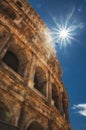 Vertical low-angle of Colosseum on a sunny day with clear sky in the background