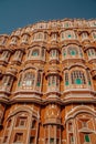 Vertical, low-angle of an exterior of The Hawa Mahal palace in Jaipur, India, with a blue sky above