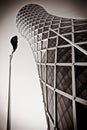 Vertical low angle of the modern Tornado Tower in Doha, in a grayscale