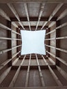 Vertical low-angle perspective view of the clear blue sky from the inside a wooden tower Royalty Free Stock Photo