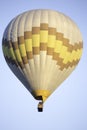 Vertical low angle shot of air balloons in the air under the clear blue sky Royalty Free Stock Photo