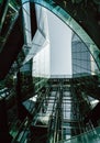 Vertical low angle shot of a beautiful modern glass building under the blue sky Royalty Free Stock Photo