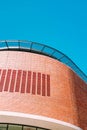 Vertical low angle shot of a brick building captured under the clear blue sky Royalty Free Stock Photo