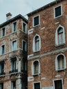 Vertical low angle shot of brick buildings building under a clear blue sky Royalty Free Stock Photo