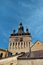 Vertical low angle shot of the Clock Tower Sighisoara in Romania under the pure blue sky Royalty Free Stock Photo