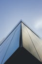 Vertical low angle shot of a corner of a modern building under the blue sky