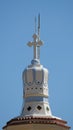 Vertical low angle shot of the cross on top of a church in Greece Royalty Free Stock Photo