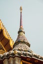 Vertical low-angle shot of the details of a Thai temple in Bangkok, Thailand.