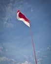 Vertical low angle shot of the Indonesian flag Royalty Free Stock Photo