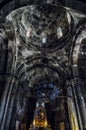 Vertical low angle shot of the inside of the historic Geghard Monastery in Armenia