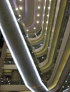 Vertical low angle shot of a lighted interior of a building with several floors Royalty Free Stock Photo