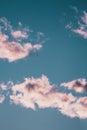 Vertical low angle shot of the magnificent fluffy clouds in the blue sky