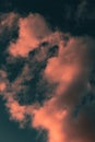 Vertical low angle shot of the magnificent fluffy clouds in the blue sky