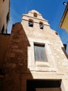 Vertical low angle shot of an old building with windows and bells in Cuenca Spain Royalty Free Stock Photo