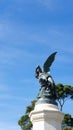 Vertical low-angle shot of a statue of a fallen angel in the Retiro Park, Madrid, Spain Royalty Free Stock Photo
