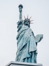 Vertical low angle shot of the Statue of Liberty replica in Tokyo, Japan under a clear sky Royalty Free Stock Photo