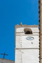 Vertical Low Angle Shot Of A White Clock Tower On Blue Sky Background