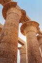 Vertical low angle view of ancient corridor and columns of Karnak temple complex in Luxor city Egpyt during sunrise with