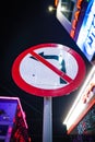 Vertical low-angle view of the no-left turn sign against the night sky