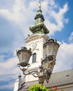 Vertical low-angle view of vintage streetlights before an old church Clock tower Royalty Free Stock Photo