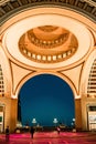 Vertical of the luxurious interior of Boston Harbor Hotel and people walking towards the exit