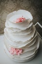 Vertical macro shot of a white wedding cake with pink roses in Sarajevo, Bosnia and Herzegovina Royalty Free Stock Photo