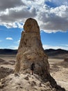 Vertical of a man stands in the desert landscape of Trona Pinnacles, California Royalty Free Stock Photo