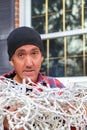 Vertical of man with tangle pile of Christmas lights Royalty Free Stock Photo