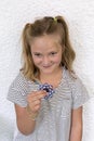 Pretty seven-year-old girl playing with toy hand spinner