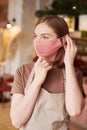 Waitress Putting On Mask