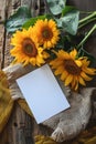 vertical mockup white blank paper card with sunflowers and burlap textile top view, floral template empty card flat lay for design Royalty Free Stock Photo