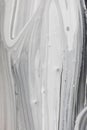 Vertical monochrome brush waves ink background. Grey white mimic texture of marble