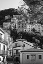Vertical monochrome shot of the houses scaling up a mountain in Lauria, Italy