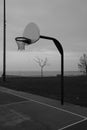 Vertical monochrome shot of the outdoors basketball hoop