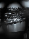Vertical monochrome shot of the Porto cityscape captured from the Luis I Bridge